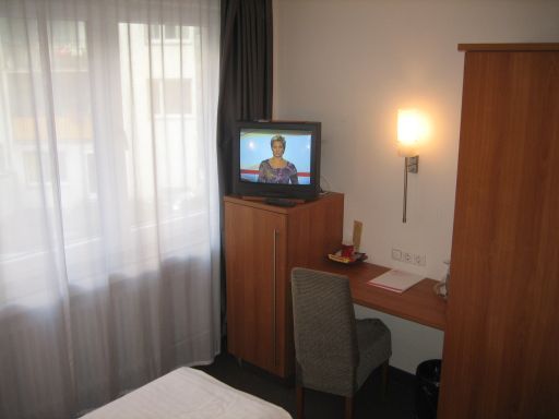 Hotel Düsseldorf Mitte, Düsseldorf, Deutschland, Fernseher, Tisch, Stuhl und Schrank