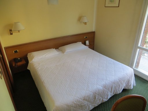 Nuovo Hotel del Porto, Bologna, Italien, Zimmer 212 mit Doppelbett, Nachttisch, Nachttischleuchten, Tür zum Bad und Balkonfenster