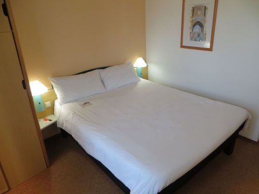 ibis Figueira da Foz Centro, Portugal, Zimmer 308 mit Doppelbett, Nachttischleuchten und Schrank