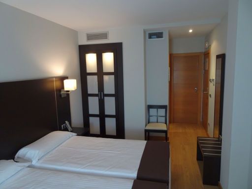 Hotel Plazaola, Irurtzun, Spanien, Zimmer 216 mit Einbauschrank, Stuhl, Trennwand zum Bad, Verbindungstür und Eingangstür