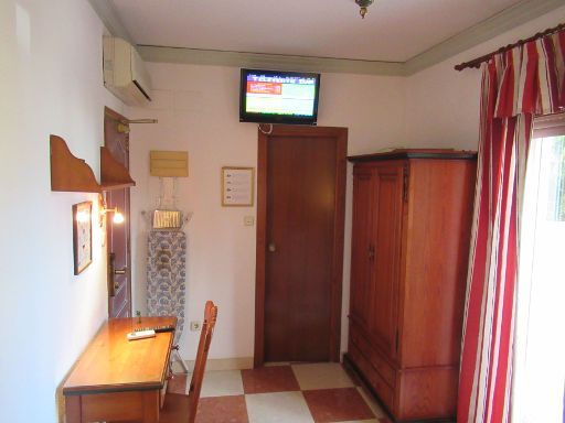 Hotel Rosa, Dénia, Spanien, Zimmer 107 mit Tisch, Stuhl, Klimaanlage, Fernseher, Schrank mit Minisafe, Tür Badezimmer und Tür Balkon