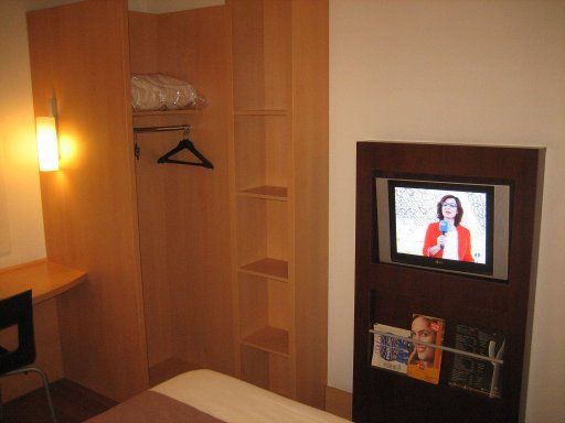 Ibis Madrid Valentin Beato, Spanien, Zimmer 204 mit offenem Schrank, Flachbildfernseher und Infomaterial