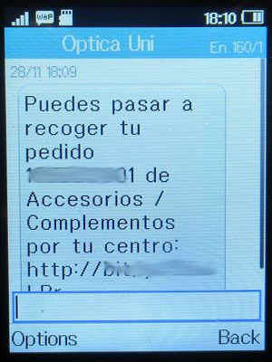 Óptica & Audiología Universitaria, Madrid, Spanien, Abholmitteilung per SMS auf einem Alcatel 2051X