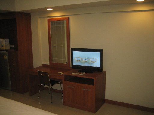 21 Living Place, Bangkok, Thailand, Zimmer 203 mit Tisch, Fernseher, Schrank und Wandspiegel